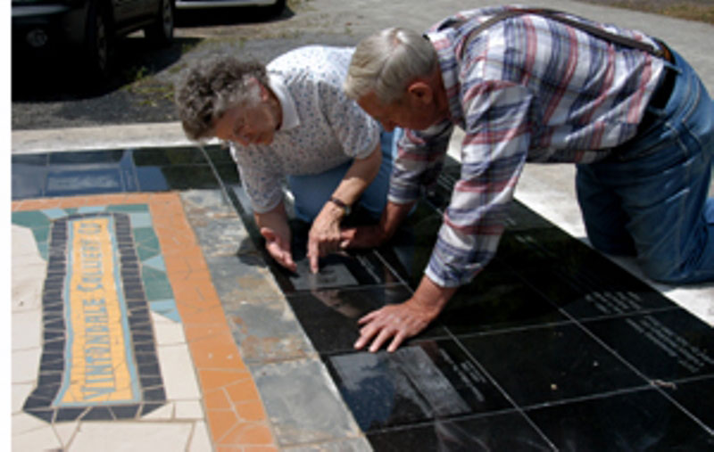 Vintondale Residents Explore the Piece and Recognize Friends on an Etched Newspaper Clipping